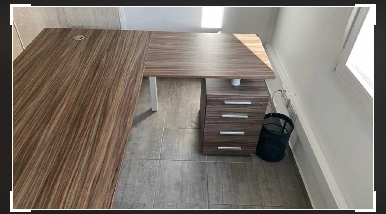 L-shaped wooden office desk with drawers
